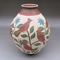 A large polychrome jar decorated with a sgraffito-and-painted cardinal, flower, leaf, branch and geometric design
 by Jesus Olivas of Mata Ortiz and Casas Grandes