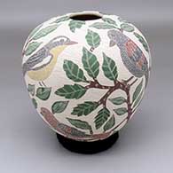 A polychrome jar with a sgraffito-and-painted songbird, leaf and branch design
 by Sandra Lorena Arras of Mata Ortiz and Casas Grandes