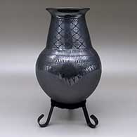 A black on black jar with flared opening, a cuadrillos and geometric design, and polished and matte texture details, click or tap to see a larger version