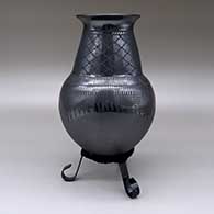 A black on black jar with flared opening, a cuadrillos and geometric design, and polished and matte texture details, click or tap to see a larger version
