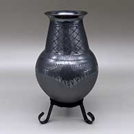 A black on black jar with flared opening, a cuadrillos and geometric design, and polished and matte texture details
 by Susy Martinez of Mata Ortiz and Casas Grandes