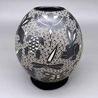 Black-on-white jar with a sgraffito rabbit, lizard, hummingbird, turtle, dragonfly, mouse, bird, and geometric design
 by Alex Ortega of Mata Ortiz and Casas Grandes