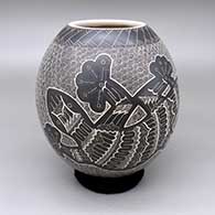 Black-on-white jar with a sgraffito lizard, spiral, and geometric design
 by Heri Mora of Mata Ortiz and Casas Grandes