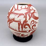 Red-on-white jar with a bold sgraffito deer, ram, bird, sun, and geometric design
 by Abraham Rodriguez of Mata Ortiz and Casas Grandes