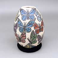 Polychrome jar with a sgraffito and painted butterfly design
 by Leticia Ledezma of Mata Ortiz and Casas Grandes