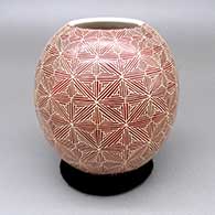 Red jar with a sgraffito fine line geometric design
 by Leonel Lopez Jr of Mata Ortiz and Casas Grandes