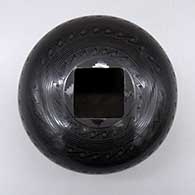 A black on black jar with a square geometric cut opening and a geometric design
 by Ruben Rodriguez of Mata Ortiz and Casas Grandes