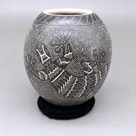 Black-on-white jar with a sgraffito lizard and geometric design
 by Heri Mora of Mata Ortiz and Casas Grandes