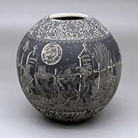 A black-on-white jar decorated with a band of sgraffito Day of the Dead at the Cemetery design with bands of sgraffito geometric design above and below
 by Hector Javier Martinez of Mata Ortiz and Casas Grandes