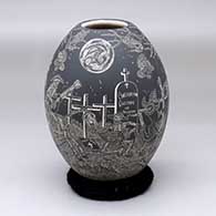 A black-on-white jar with a Night of the Dead at the Cemetery with the rabbit in the full moon design
 by Hector Javier Martinez of Mata Ortiz and Casas Grandes