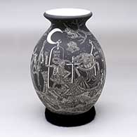 A black-and-white jar with a rolled lip and decorated with a sgraffito Night of the Dead at the cemetery design
 by Hector Javier Martinez of Mata Ortiz and Casas Grandes