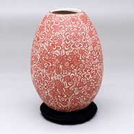 A red-on-white vase with a sgraffito geometric design
 by Hector Javier Martinez of Mata Ortiz and Casas Grandes