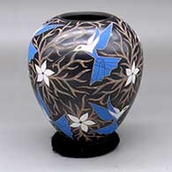 A polychrome jar decorated with a sgraffito-and-painted hummingbird, flower and vine design
 by Elicena Cota of Mata Ortiz and Casas Grandes