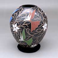 A polychrome jar decorated with a sgraffito-and-painted bird, flower and vine design
 by Elicena Cota of Mata Ortiz and Casas Grandes