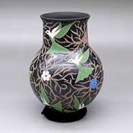 A polychrome vase with a flared rim and decorated with a sgraffito-and-painted hummingbird, flower and vine design
 by Elicena Cota of Mata Ortiz and Casas Grandes
