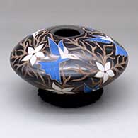 A polychrome jar decorated with a sgraffito-and-painted bird, flower and vine design
 by Elicena Cota of Mata Ortiz and Casas Grandes