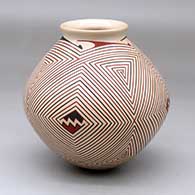 A polychrome jar with a rolled lip and decorated with a four-panel spiraling fine line and geometric design
 by Pilo Mora of Mata Ortiz and Casas Grandes