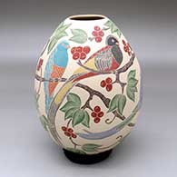 A polychrome jar decorated with a sgraffito-and-painted bird, branch, leaf and berry design
 by Guadalupe Melendez of Mata Ortiz and Casas Grandes