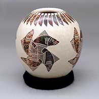 A polychrome jar decorated with a sgraffito and painted four-panel fish, feather and geometric design
 by Leonel Lopez Sr of Mata Ortiz and Casas Grandes