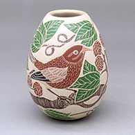 A polychrome jar decorated with a sgraffito-and-painted bird, berry, leaf and branch design
 by Guadalupe Melendez of Mata Ortiz and Casas Grandes