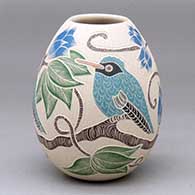 A polychrome jar decorated with a sgraffito-and-painted bird, branch, leaf and flower design
 by Guadalupe Melendez of Mata Ortiz and Casas Grandes