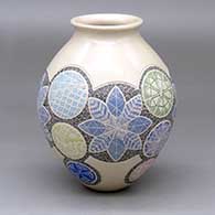 A polychrome jar with a rolled lip and decorated with a sgraffito-and-painted flower, leaf and geometric design
 by Shelyz Amaya of Mata Ortiz and Casas Grandes