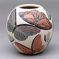 A polychrome jar decorated with a sgraffito-and-painted butterfly design
 by Adhilenne Figueroa of Mata Ortiz and Casas Grandes