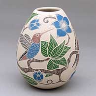 A polychrome jar decorated with a four-panel sgraffito-and-painted bird, leaf, flower and branch design
 by Guadalupe Melendez of Mata Ortiz and Casas Grandes