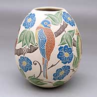 A polychrome jar decorated with a sgraffito-and-painted bird, branch, leaf and flower design
 by Guadalupe Melendez of Mata Ortiz and Casas Grandes
