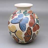 A polychrome jar with a rolled lip and decorated with a plethora of sgraffito-and-painted butterfly designs
 by Adhilenne Figueroa of Mata Ortiz and Casas Grandes