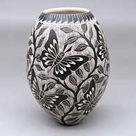 A black-and-white jar decorated with a four-panel butterfly leaf and branch design
 by Unknown of Mata Ortiz and Casas Grandes