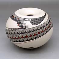 A polychrome seed pot decorated with a Paquime-inspired serpent and geometric design
 by Celia Veloz of Mata Ortiz and Casas Grandes