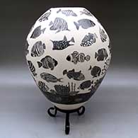 A black-on-white jar decorated with a lightly-carved and sgraffito tropical fish and coral reef design, click or tap to see a larger version