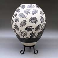 A black-on-white jar decorated with a lightly-carved and sgraffito tropical fish and coral reef design, click or tap to see a larger version