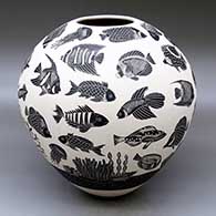 A black-on-white jar decorated with a lightly-carved and sgraffito tropical fish, jellyfish, squid and coral reef design
 by Adrian Corona of Mata Ortiz and Casas Grandes