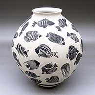 A black-on-white jar with a flared lip and decorated with a lightly-carved and sgraffito tropical fish and jellyfish design
 by Adrian Corona of Mata Ortiz and Casas Grandes