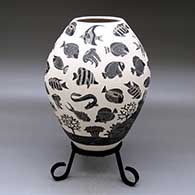 A black-on-white jar decorated with a sgraffito underwater scene of tropical fish and a coral reef
 by Adrian Corona of Mata Ortiz and Casas Grandes