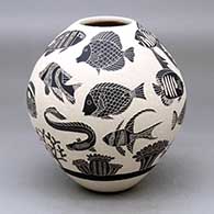 A black-on-white jar decorated with a lightly-carved and sgraffito tropical fish and coral reef design
 by Adrian Corona of Mata Ortiz and Casas Grandes