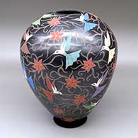 A polychrome jar decorated with a sgraffito and painted hummingbird, vine and flower design
 by Elicena Cota of Mata Ortiz and Casas Grandes