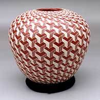 A red and white jar decorated with a sgraffito 3D geometric design
 by Jorge Quintana of Mata Ortiz and Casas Grandes