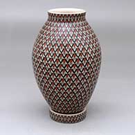 A polychrome vase decorated with a geometric design and with a matching custom stand
 by Olga Arras of Mata Ortiz and Casas Grandes