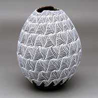 A white-on-brown jar with an organic opening and flowing geometric design
 by Aide Gonzales of Mata Ortiz and Casas Grandes