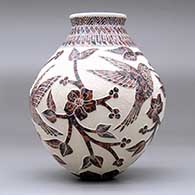 A polychrome jar decorated with a hummingbird, vine, flower and geometric design, click or tap to see a larger version