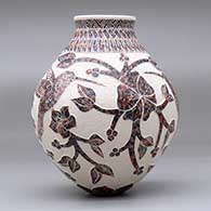 A polychrome jar decorated with a hummingbird, vine, flower and geometric design, click or tap to see a larger version