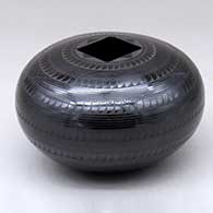 A black on black jar decorated with bands of geometric design
 by Ruben Rodriguez of Mata Ortiz and Casas Grandes