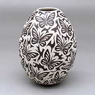 A polychrome jar decorated with a sgraffito butterfly and geometric design
 by David Bejarano of Mata Ortiz and Casas Grandes