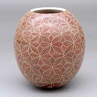 A red-on-white jar decorated with a sgraffito fine line snowflake geometric design
 by Leonel Lopez Jr of Mata Ortiz and Casas Grandes