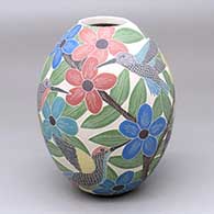 A polychrome jar decorated with a sgraffito-and-painted hummingbird, butterfly, flow and vine design
 by Blanca Arras of Mata Ortiz and Casas Grandes