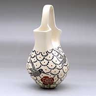 A polychrome wedding vase with square spouts and decorated with a sgraffito and painted hummingbird, flower and geometric design, click or tap to see a larger version