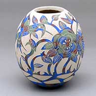 A polychrome jar decorated with a sgraffito hummingbird, flower, leaf, vine and geometric design
 by Diana Loya of Mata Ortiz and Casas Grandes